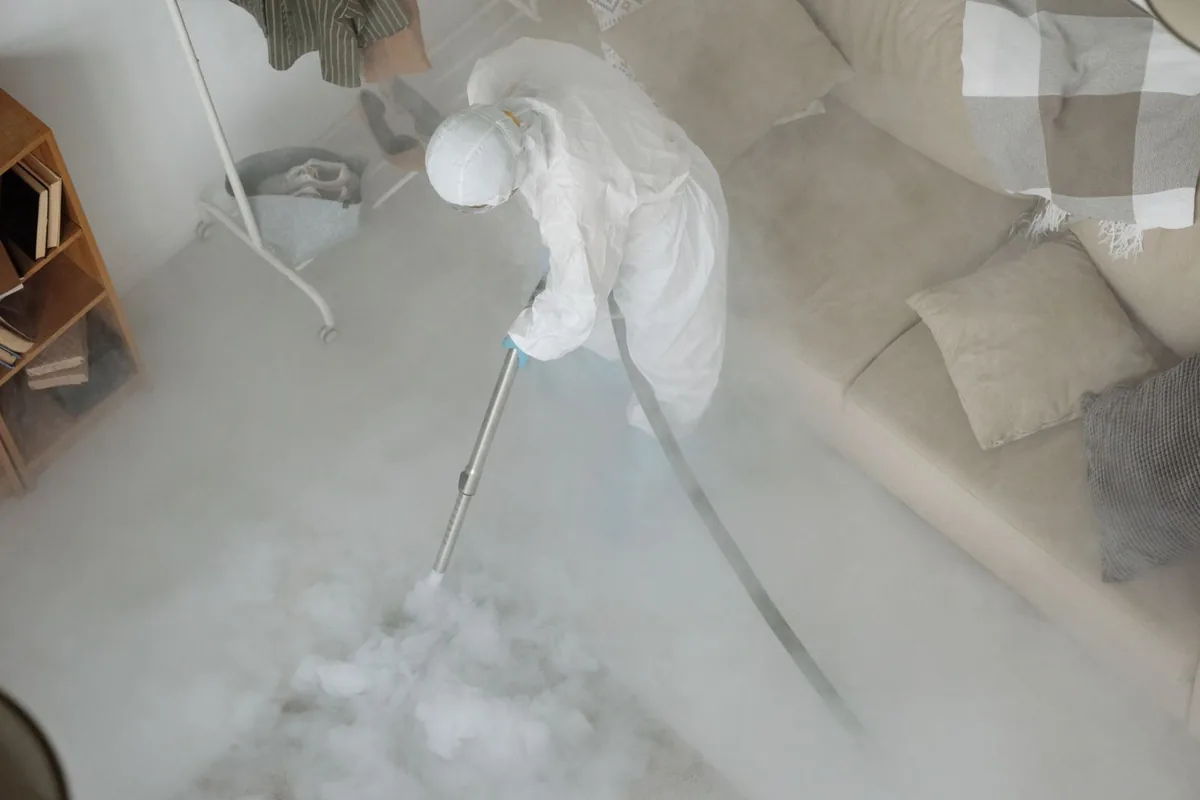 Biohazard cleanup technician in protective equipment, Scott City, MO